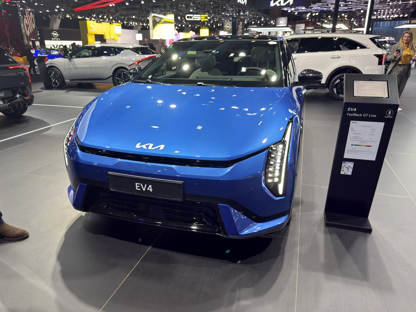 Front view of a blue EV hatch with vertical LED headlights
