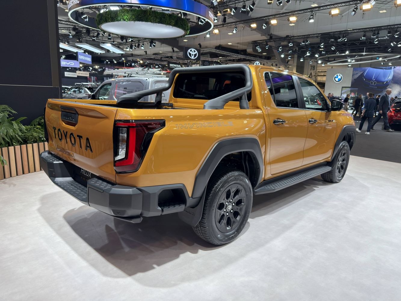 Pickup rear with truck bed, modern tail lights, and side steps.