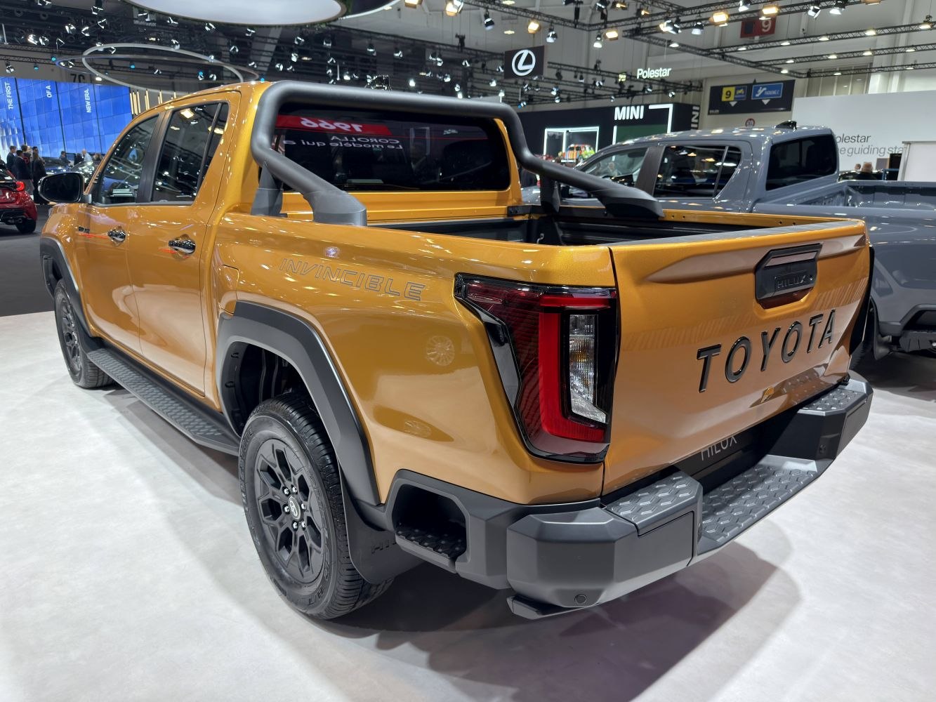 Modern pickup rear design with black wheels and distinctive lighting