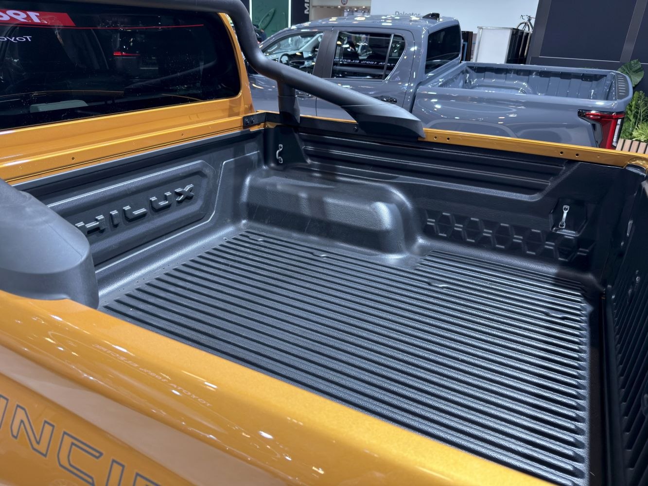 Pickup bed liner with reinforced cargo area and embossed branding