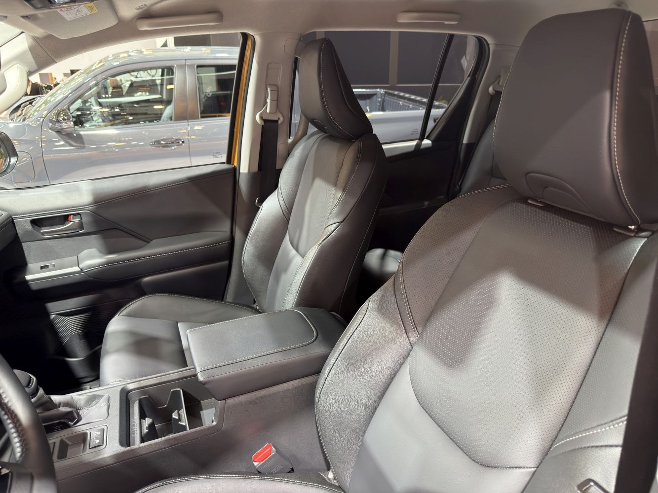 Modern leather front seats and armrest in a double cab interior