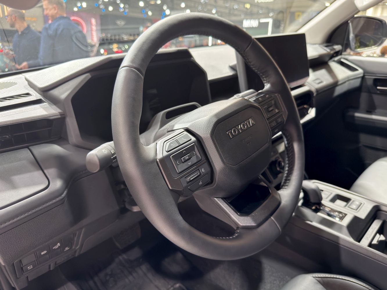 Steering wheel and dashboard with controls in vehicle interior