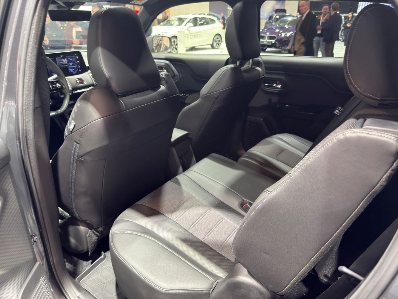 Rear seating and interior cabin of a modern SUV with black leather upholstery