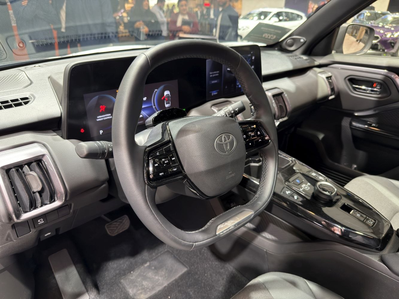 Modern steering wheel and digital dashboard display in car interior