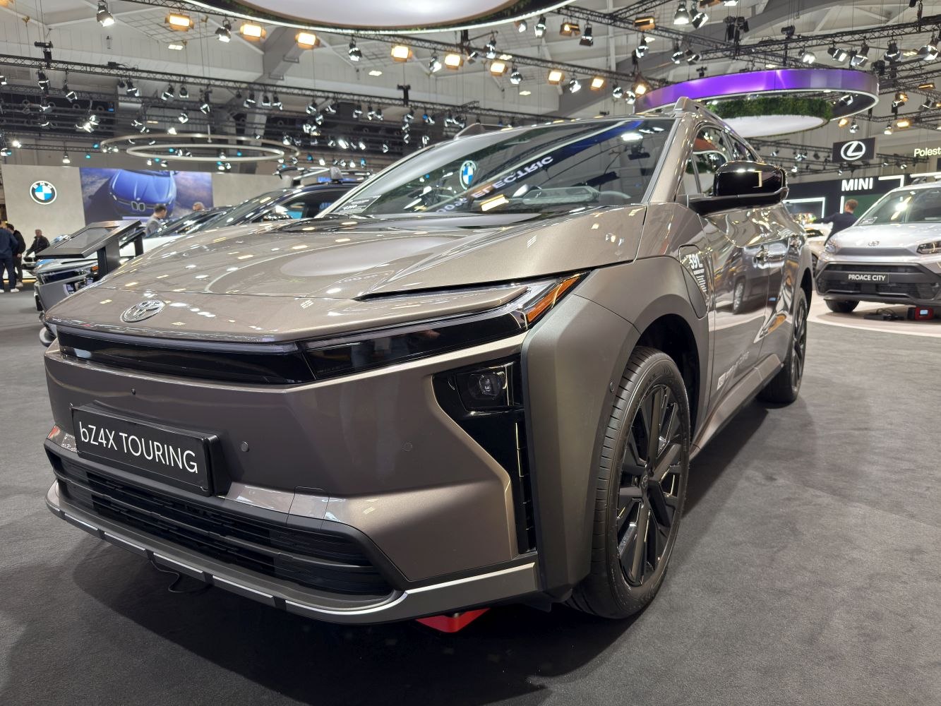 Front and side view of electric SUV with sleek headlights and aerodynamic body.