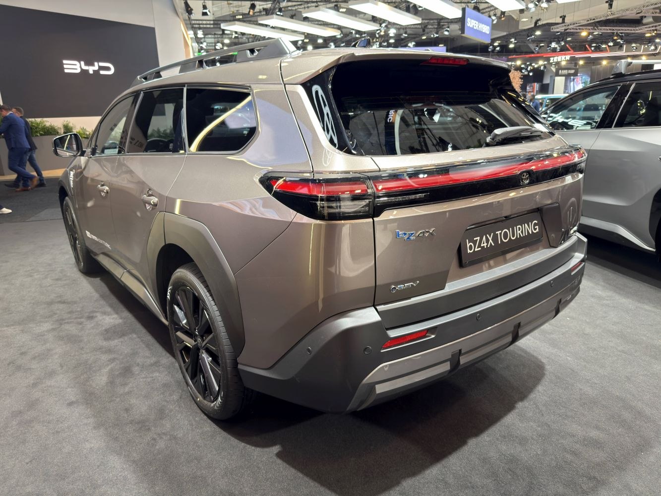 Rear view of a modern electric SUV with sleek tail lights and roof rails