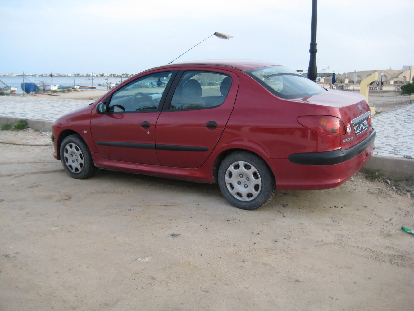 Side profile of compact sedan with smooth rear and rounded taillights