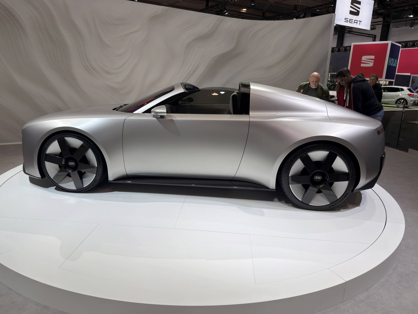 Sleek silver convertible coupe with aerodynamic design and modern wheels.