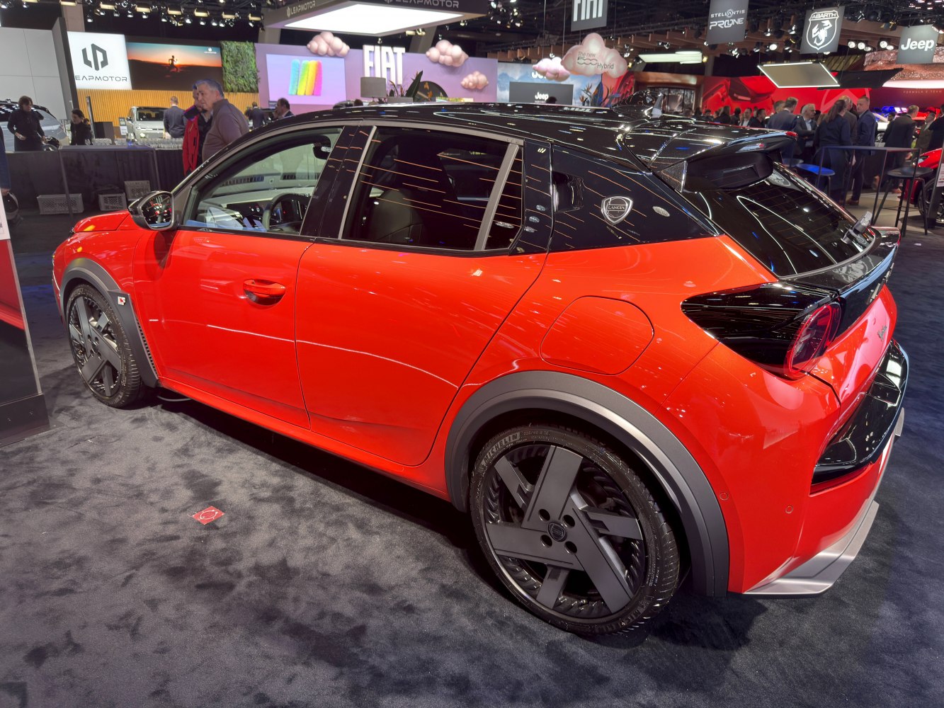 Side and rear view of a subcompact hatchback with black roof and black alloy wheels