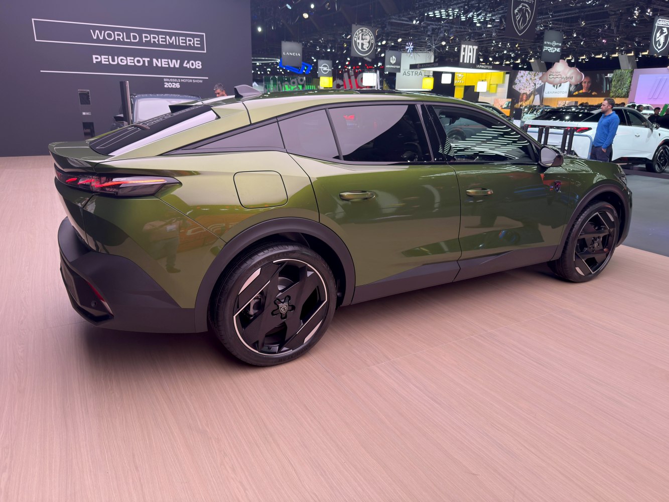 Rear-side view of green crossover with angular rear design and distinctive wheels