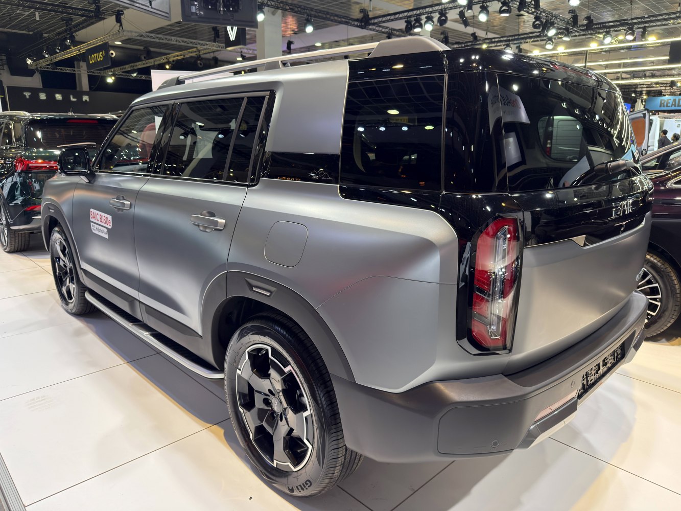 Matte silver compact SUV with black rear, unique tail lights, and alloy wheels.