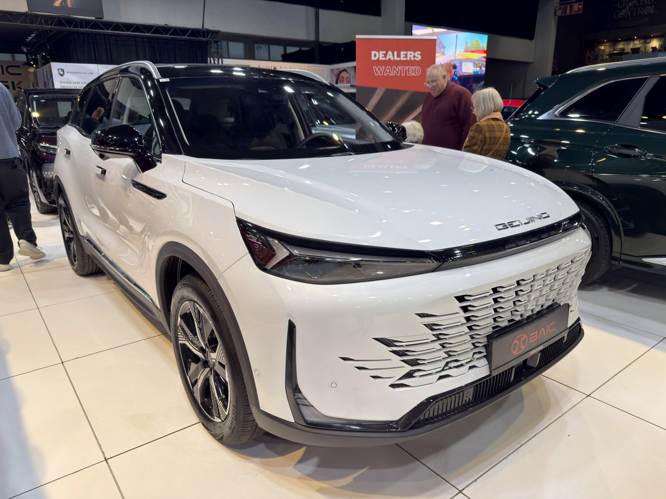 Sleek front grille and sharp headlights of a modern SUV.