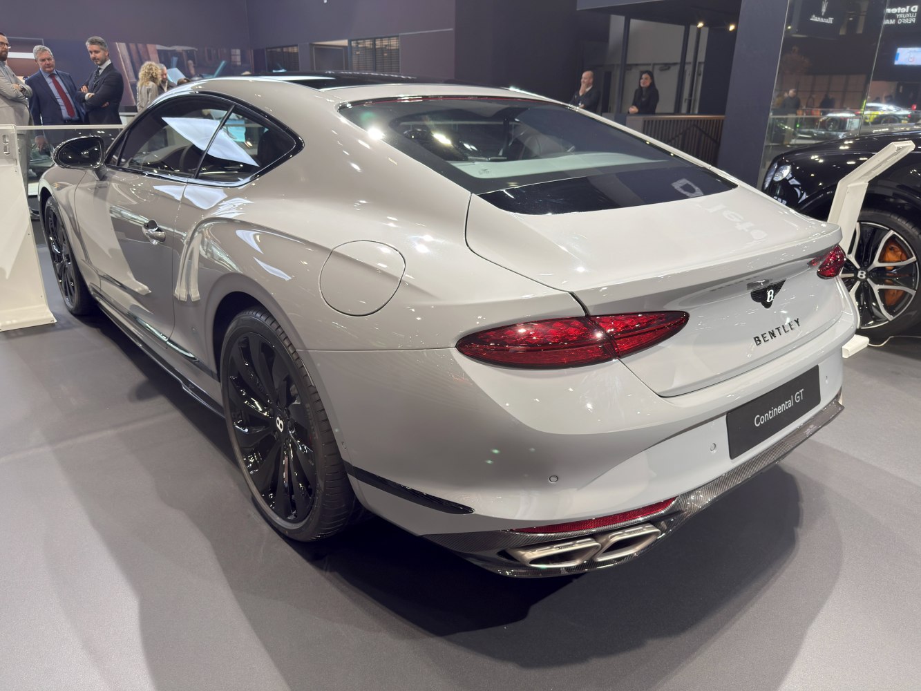 Rear view of luxury coupe with quad exhaust and black wheels