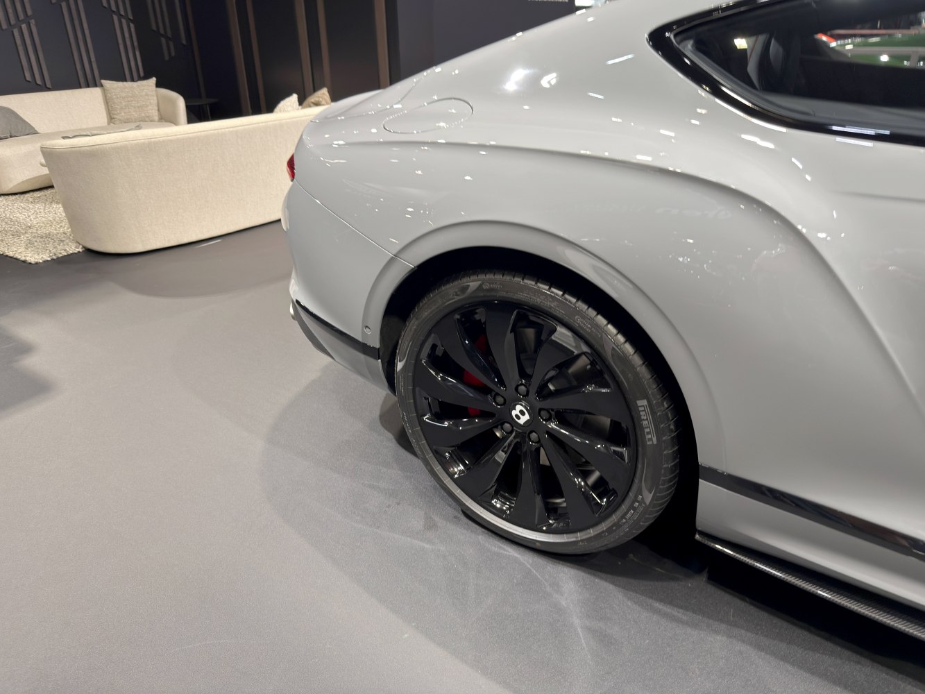 Black alloy rear wheel with fender and brake caliper detail