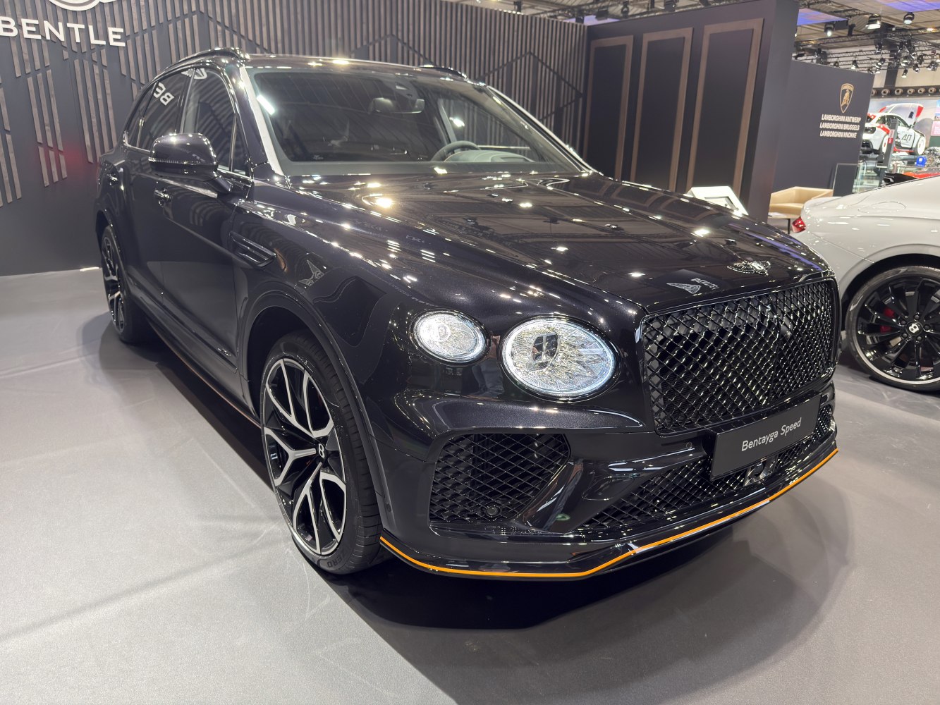 Luxury SUV front with diamond grille and multi-spoke alloy wheels