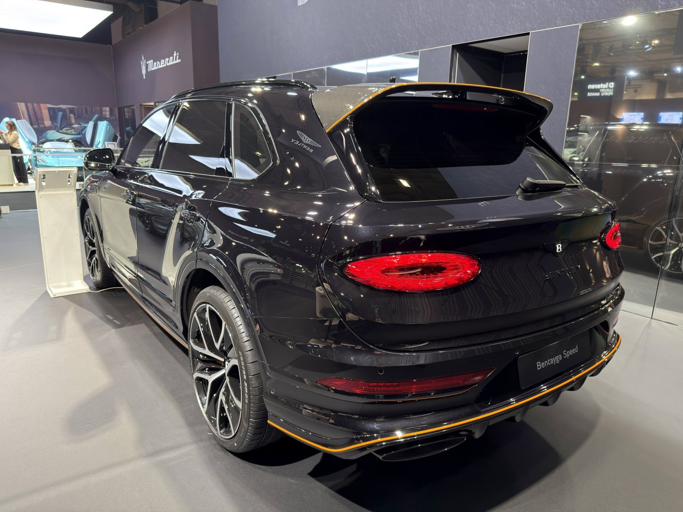 Rear view of luxury SUV with distinctive LED taillights and sporty rear spoiler.