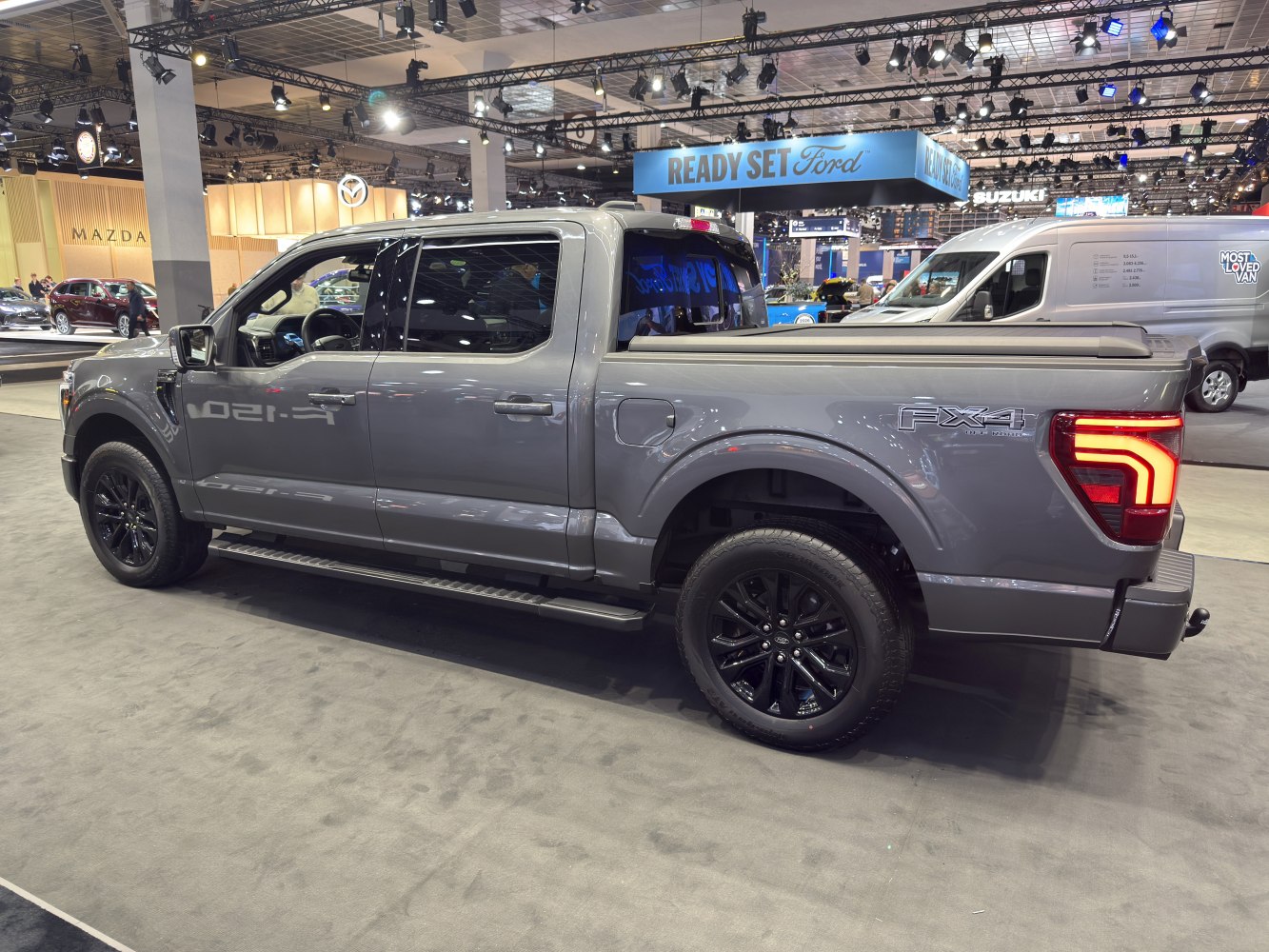Pickup truck with crew cab, black wheels, FX4 badge, and tonneau cover