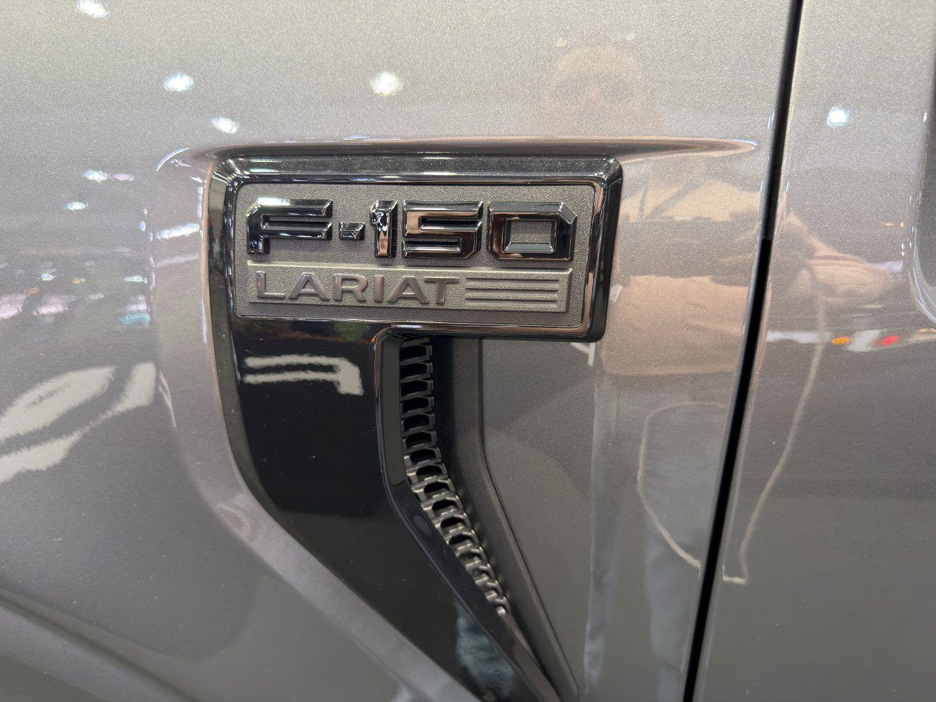 Close-up of a chrome F-150 Lariat side emblem and vent.