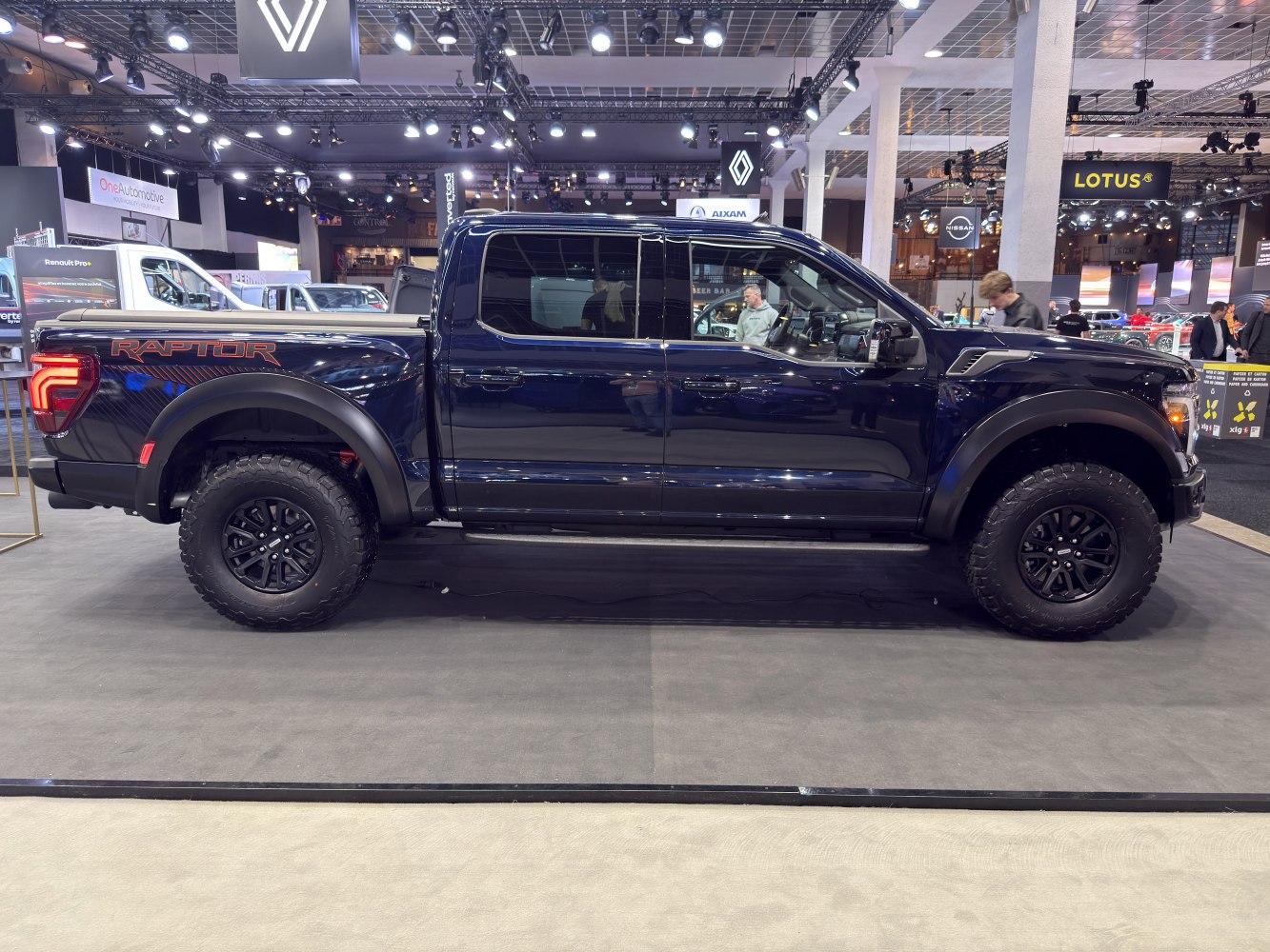 Side profile of 2024 pickup with off-road tires and Raptor decal