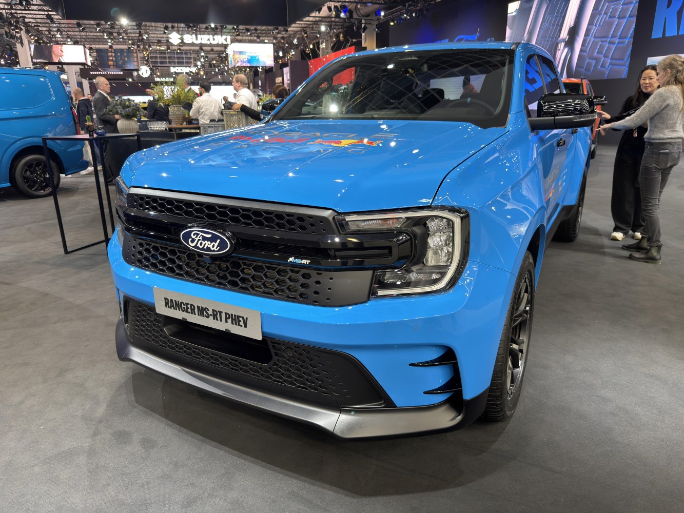 Front view of blue pickup with sleek headlights and bold grille