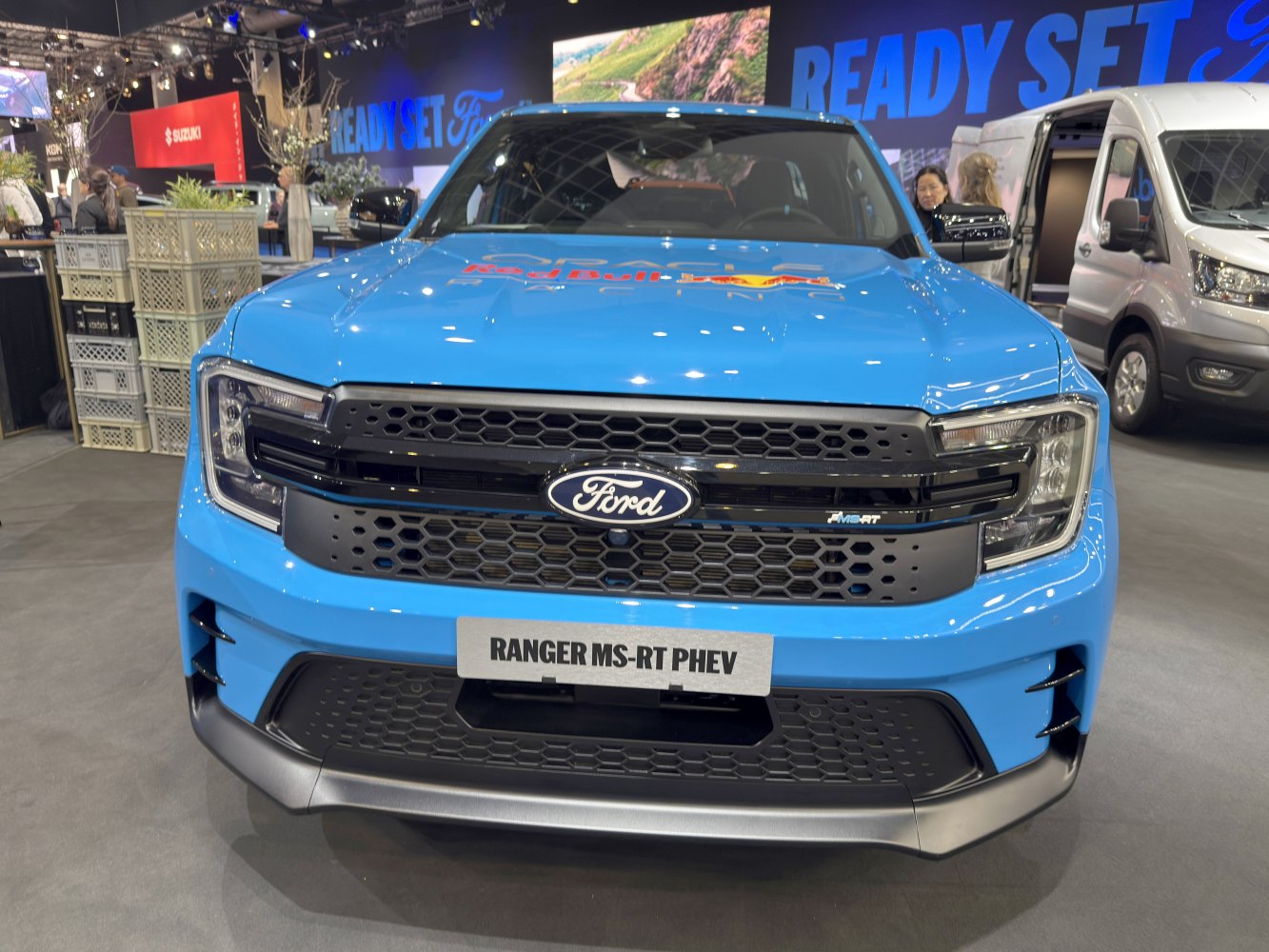 Close-up of front grille and headlights with honeycomb pattern and aerodynamic bumper.