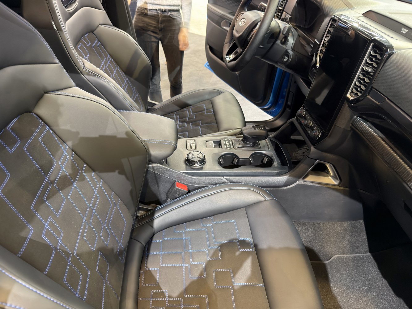 Modern vehicle interior with patterned stitching and central control console
