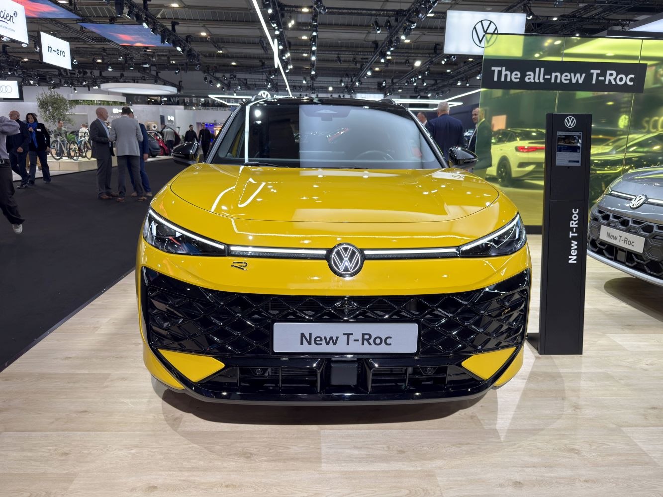 Yellow SUV front with sleek LED headlights and textured grille