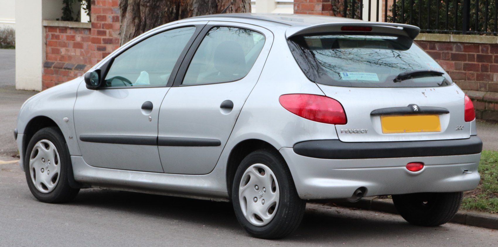 Silver five-door hatchback rear-side view with distinct taillights and small exhaust