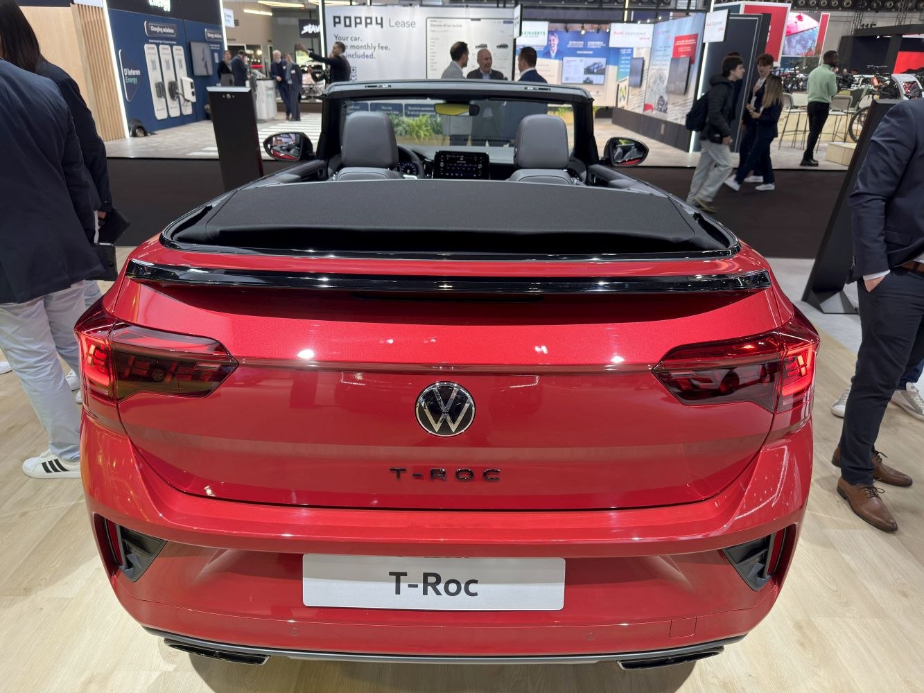Rear view of red convertible with soft top and modern taillights