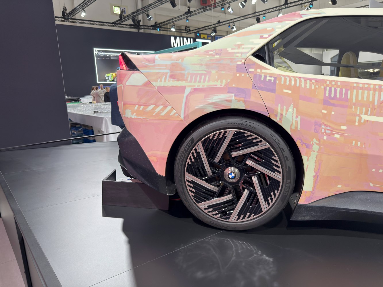 Close-up of rear wheel with unique rim and futuristic tail light design