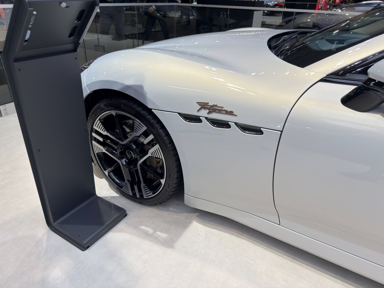 Side vent with triple grills and modern black multi-spoke wheel