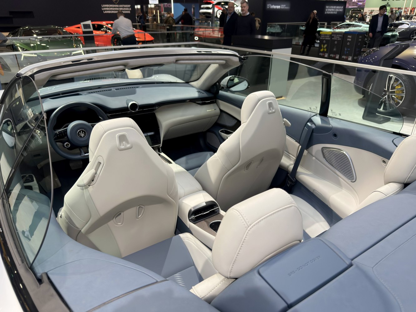 Convertible interior with white leather seats and modern digital dashboard