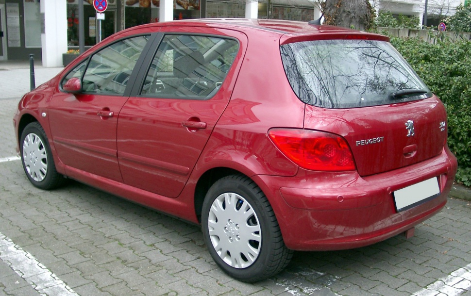 Rear and side profile of a red 5-door hatchback.