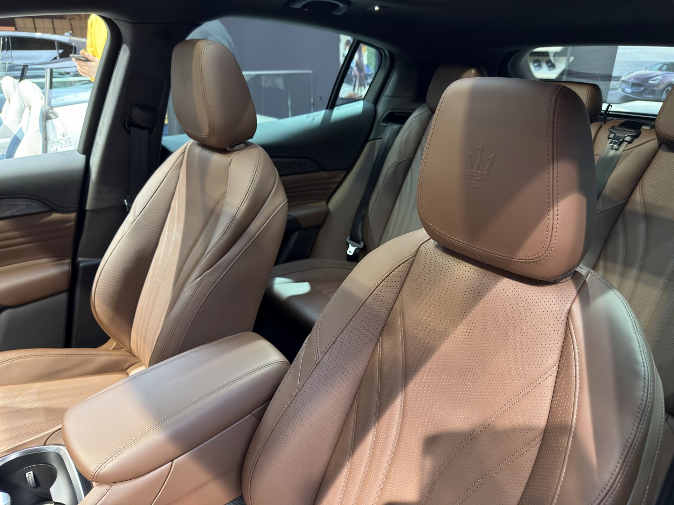Brown leather seats with embossed headrests and detailed stitching