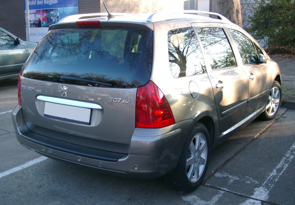 Rear and side view showing taillights, spoiler, and alloy wheels