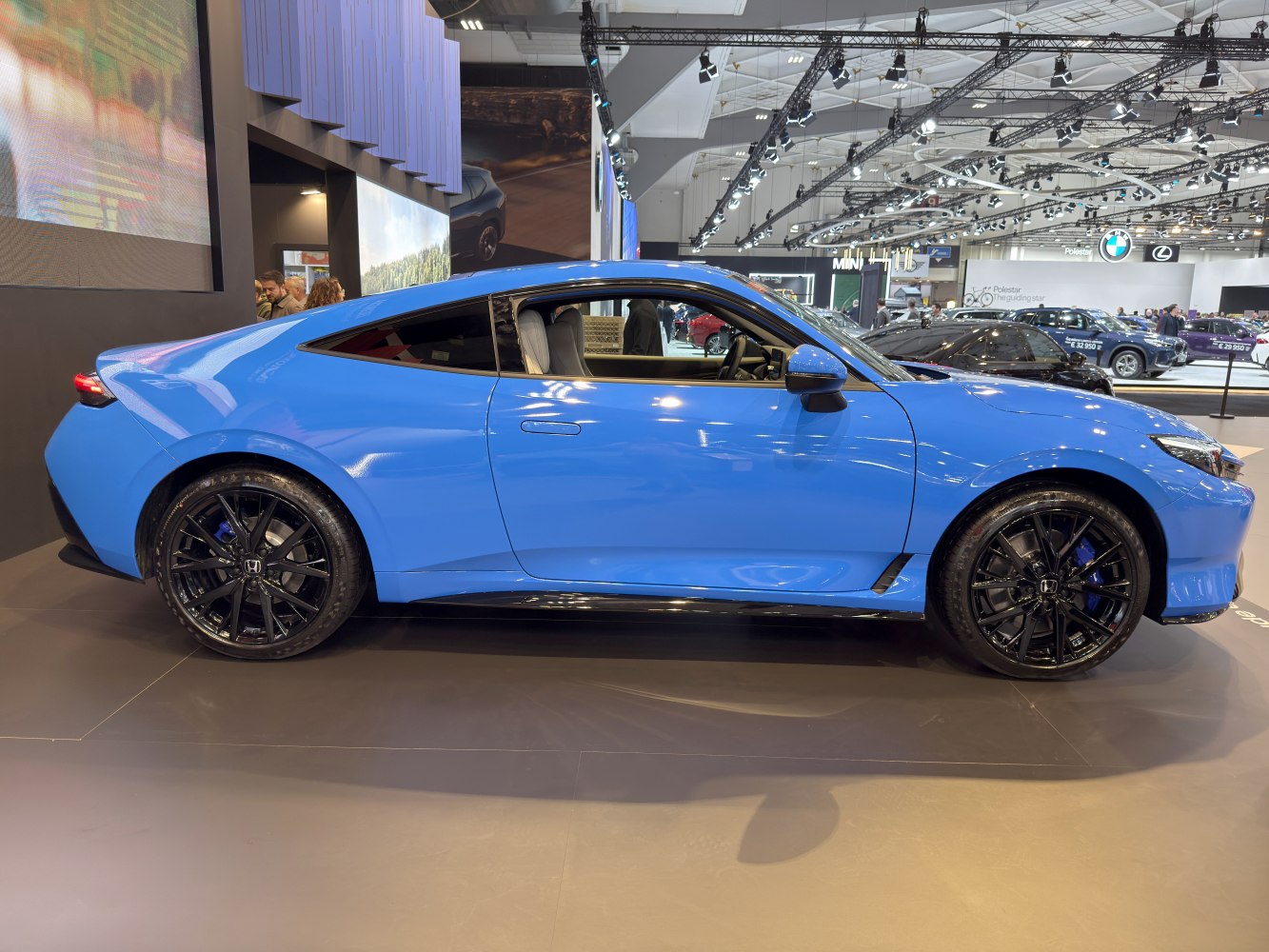 Blue coupe with aerodynamic body and black alloy wheels