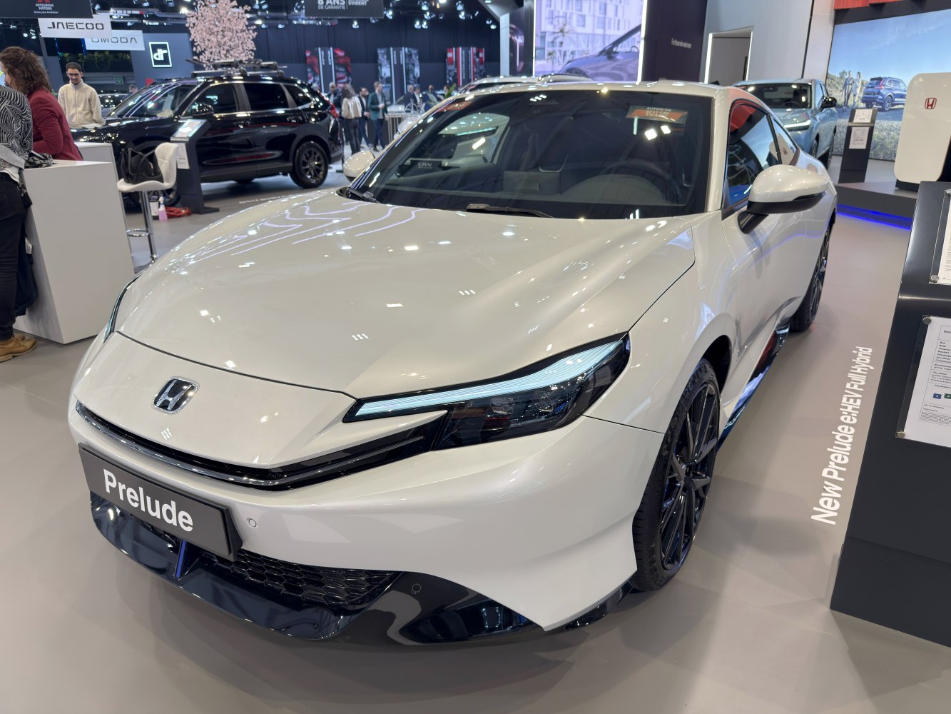 Sleek front view with LED headlights of a modern hybrid sports coupe.