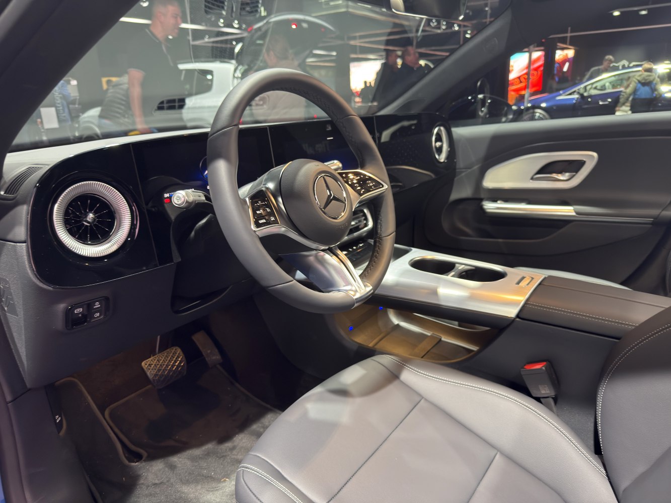 Modern luxury car interior with steering wheel and dashboard