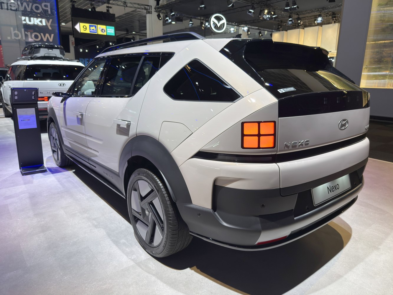 Futuristic SUV rear with square tail lights and aerodynamic design.