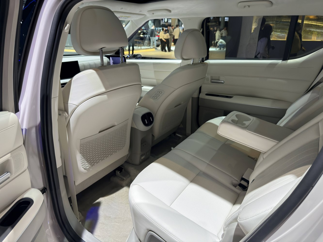 White leather rear seats with folding armrest in spacious car interior