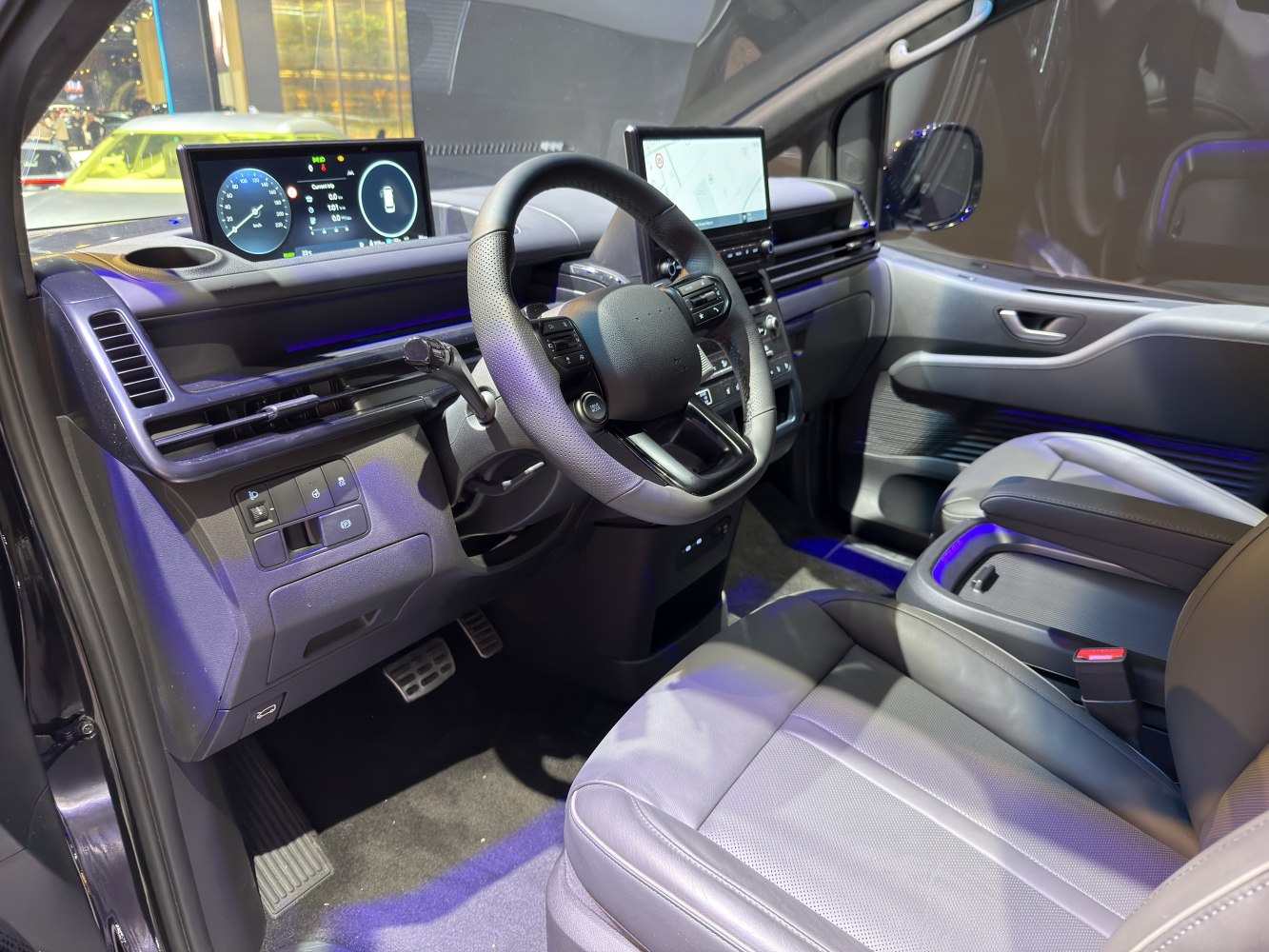 Modern car interior with dual digital display screens and ergonomic steering wheel