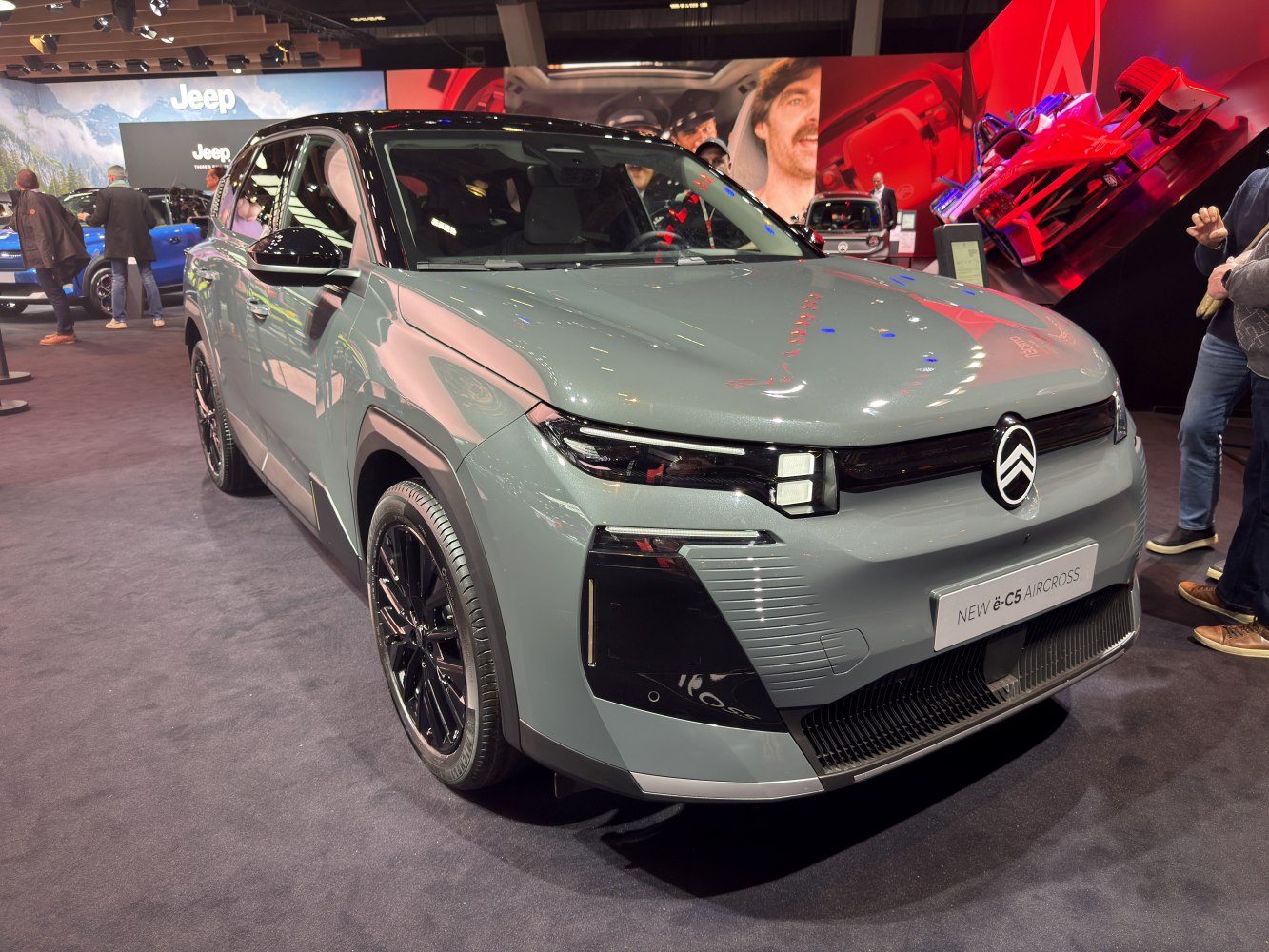 Front view of electric SUV with sleek headlights and modern grille