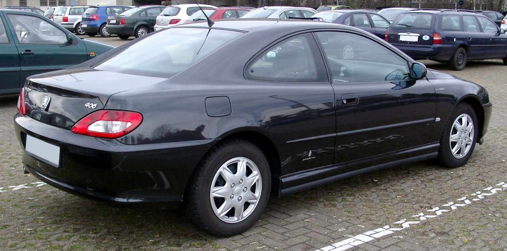 Rear and side view of a compact coupe with distinct taillights.