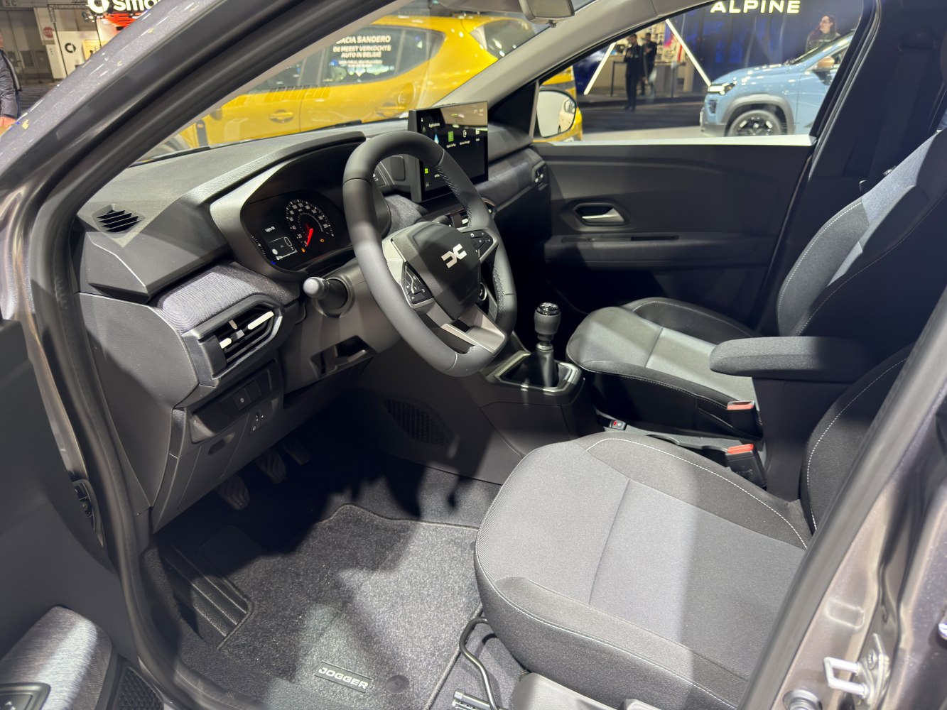 Manual transmission cabin with modern dashboard and fabric seats