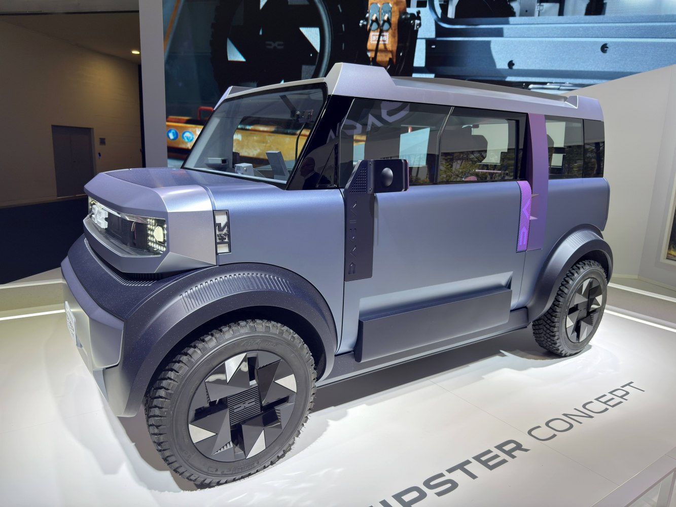 Futuristic boxy SUV with angular body and unique cross-pattern wheels