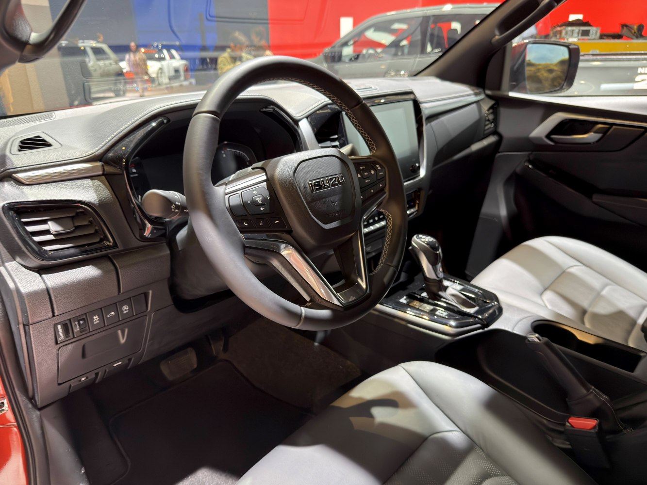 Steering wheel with control buttons and center console with gear shifter