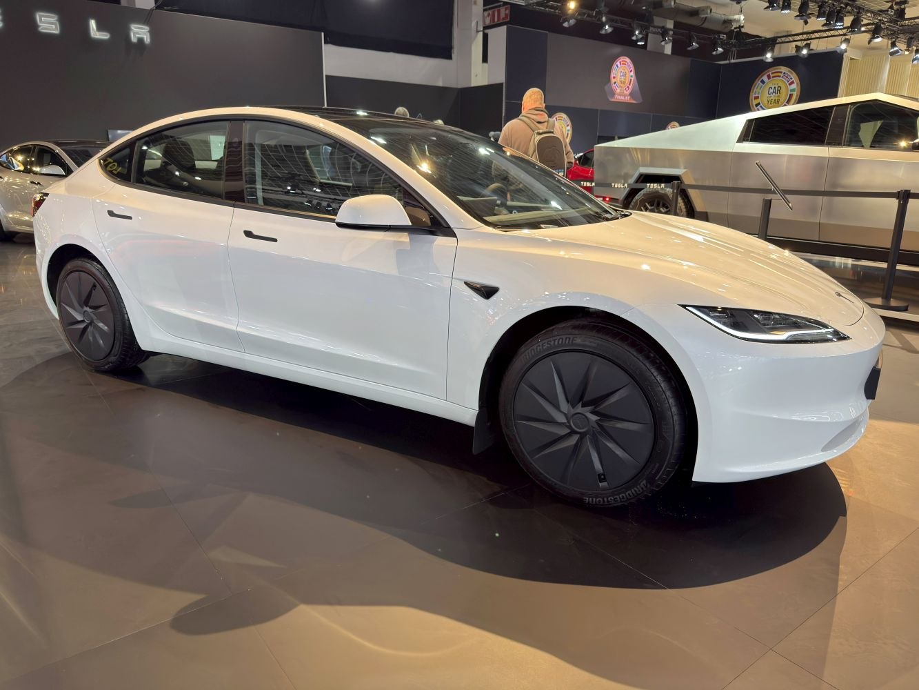 Side profile of a sleek aerodynamic electric sedan with stylish dark wheels.
