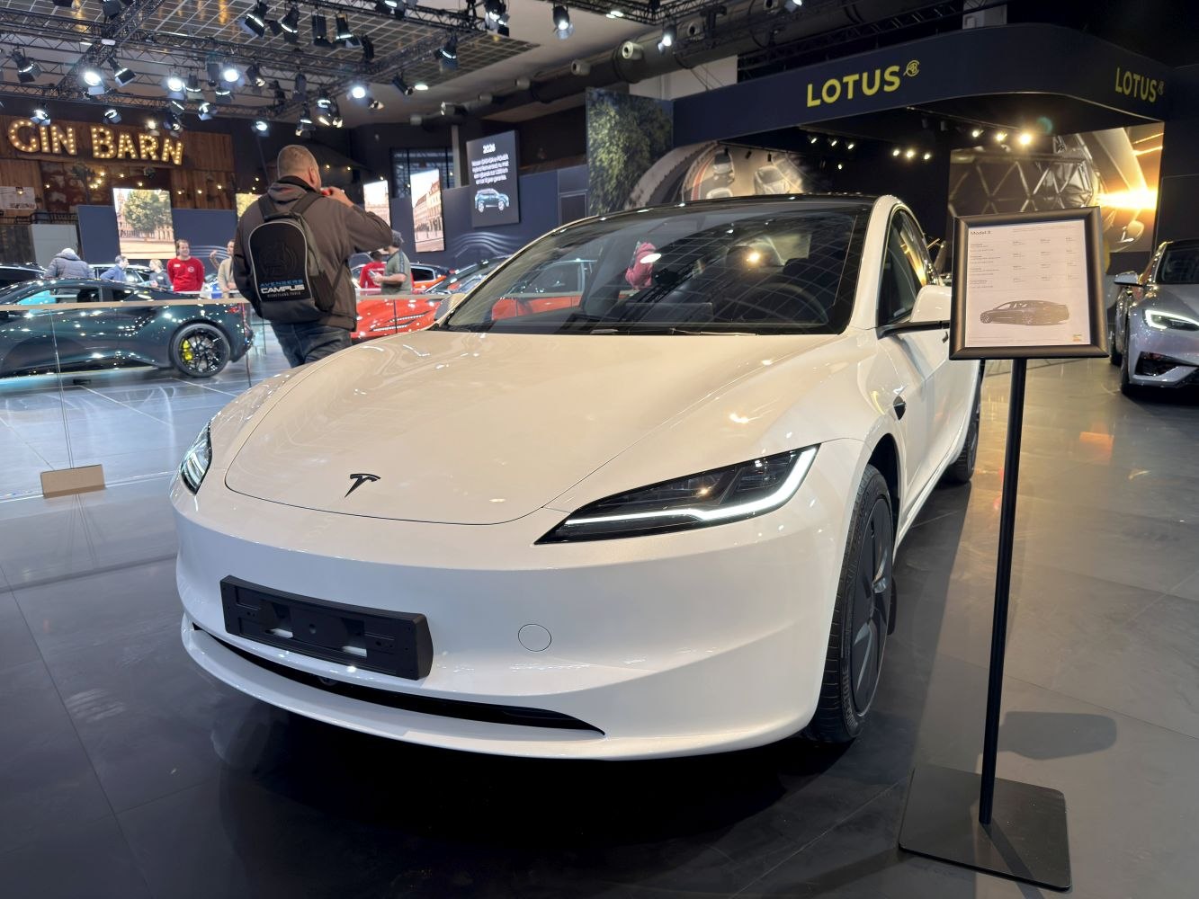 Front view of a white electric sedan with sleek LED headlights and smooth aerodynamic design