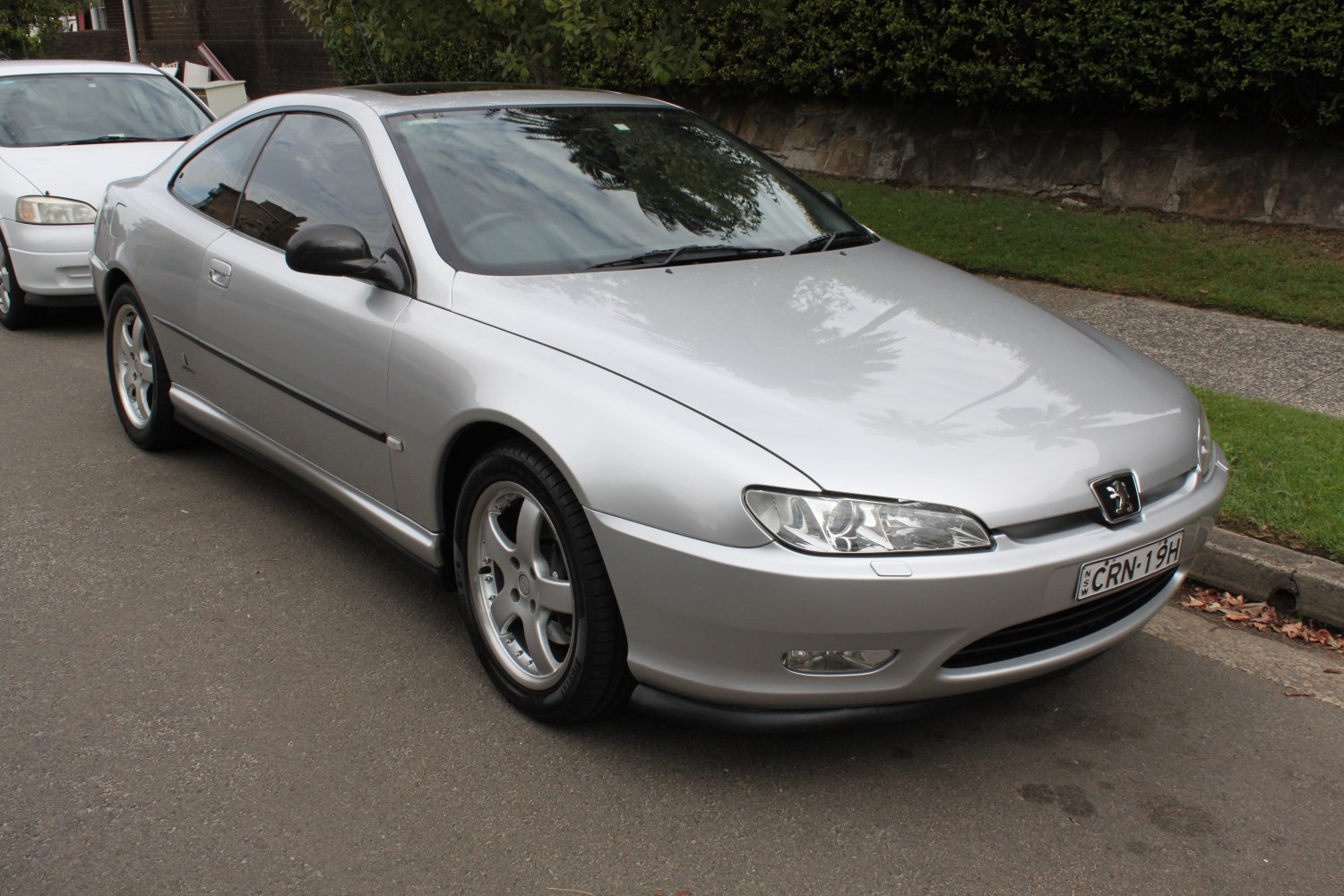Silver 1997 coupe with sleek front side and alloy wheels