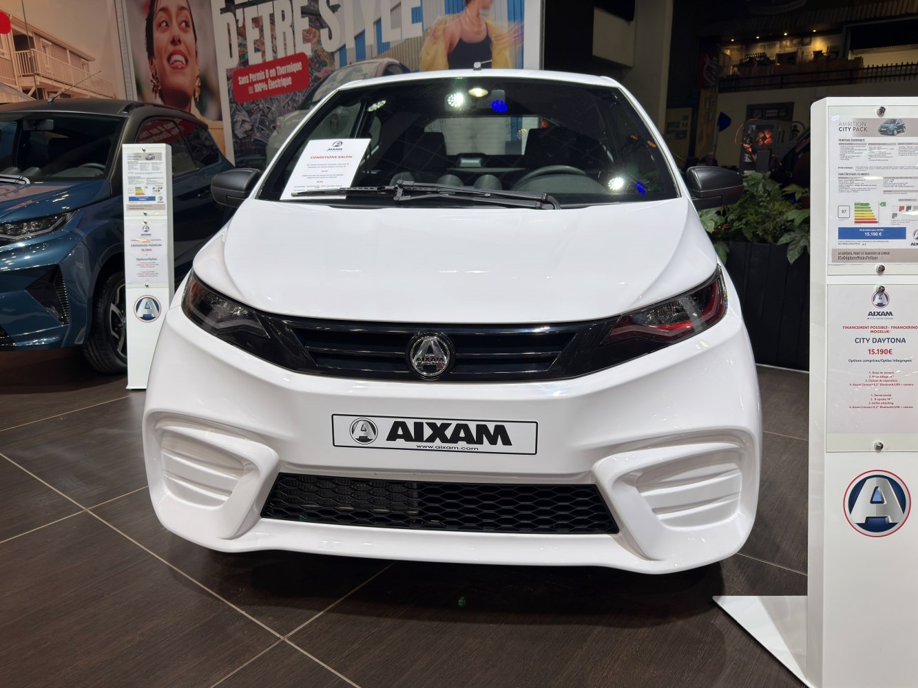 Front view showcasing sleek headlights and grille of a compact microcar.